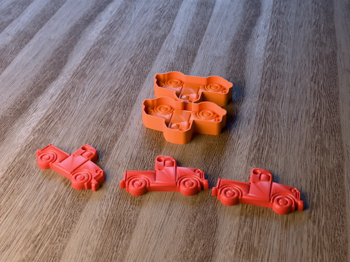 3D render of the printed caster for a two-cavity vintage truck freshie mold, with three red pickup truck car freshies with round fenders in front