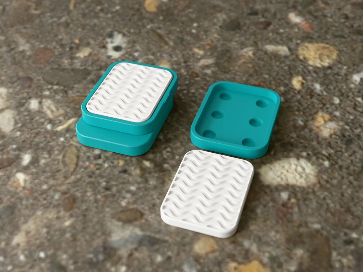 3D render of a teal and white 3D-printed magnetic fidget slider with a waves texture, assembled, next to a spare plate and insert