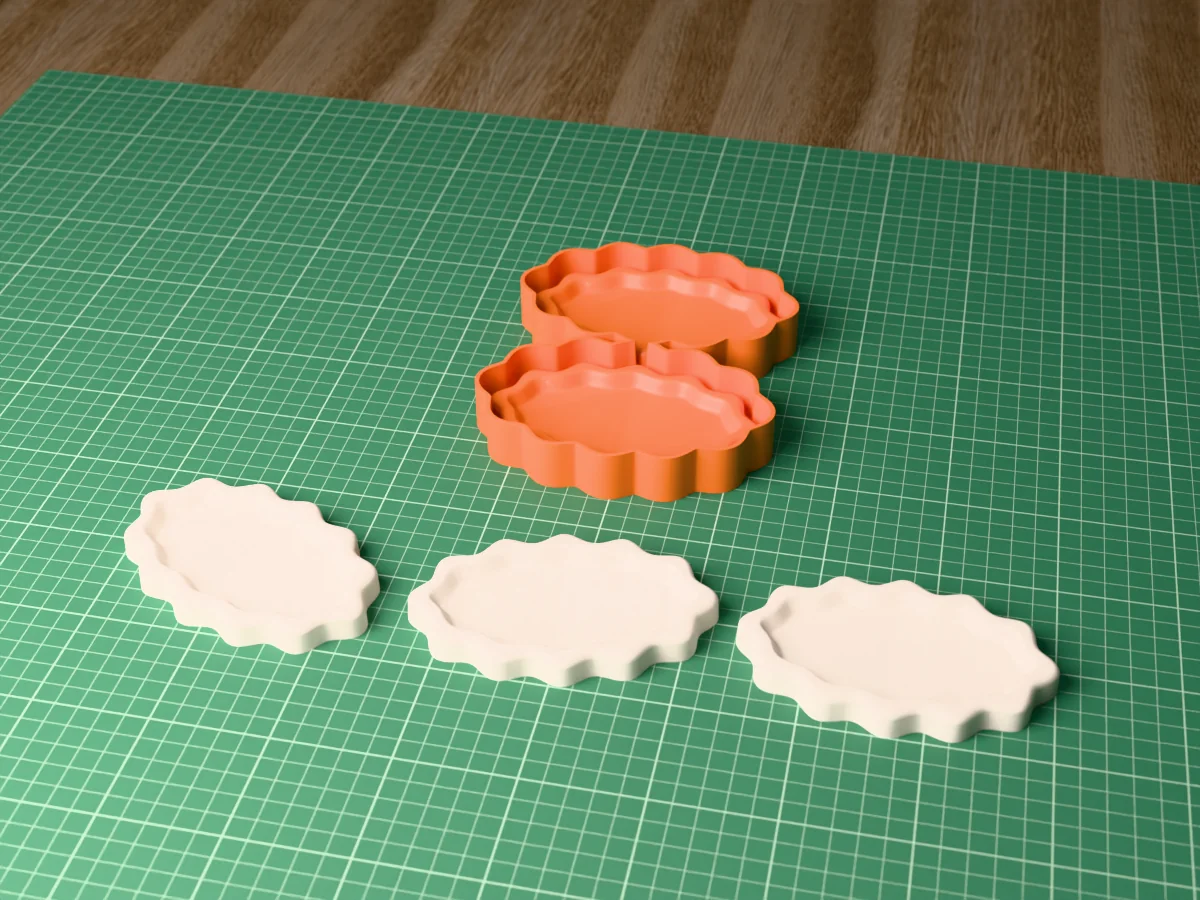 3D render of the printed caster for a two-cavity silicone mold of wavy trinket trays, with three white wavy trays in front