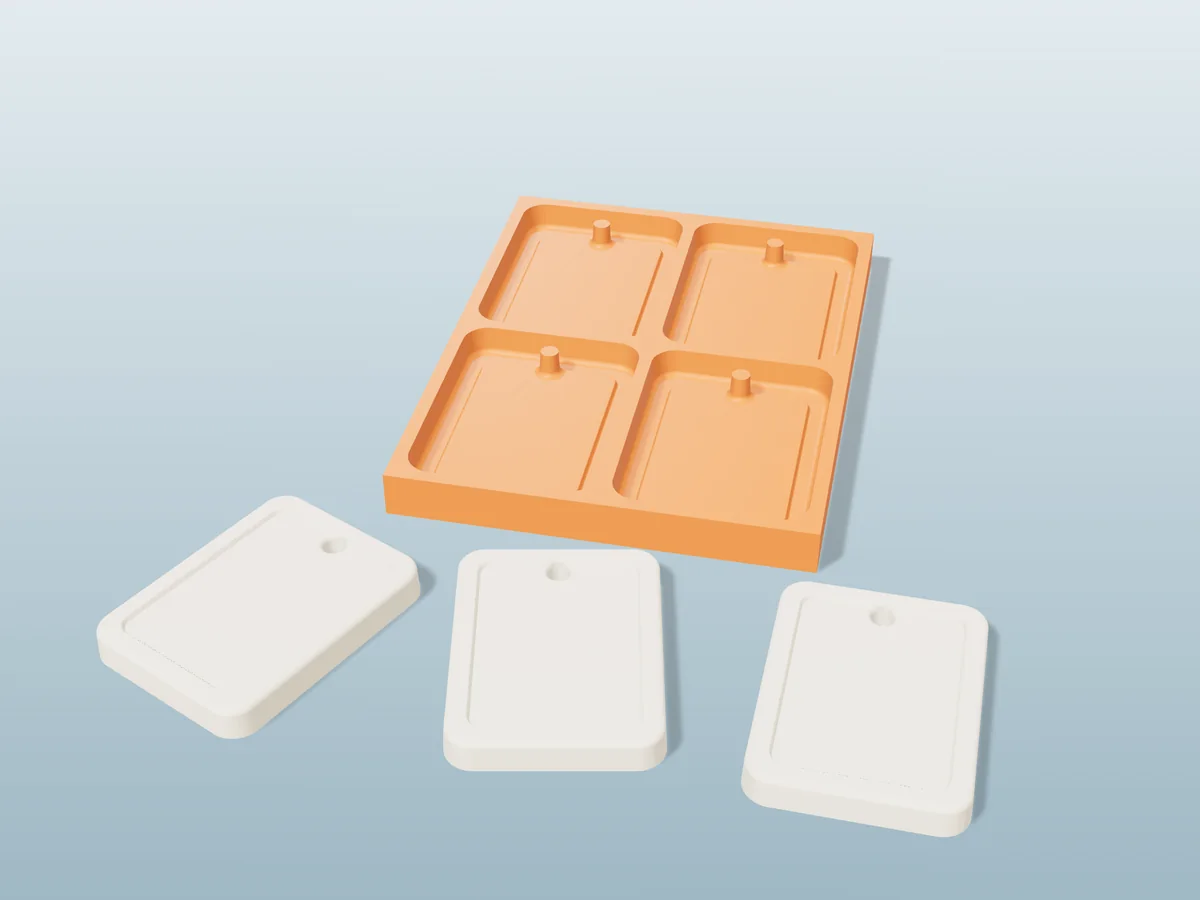 3D render of a printed orange tray with four wax sachet cavities, and three cream wax sachets with hanging holes in front