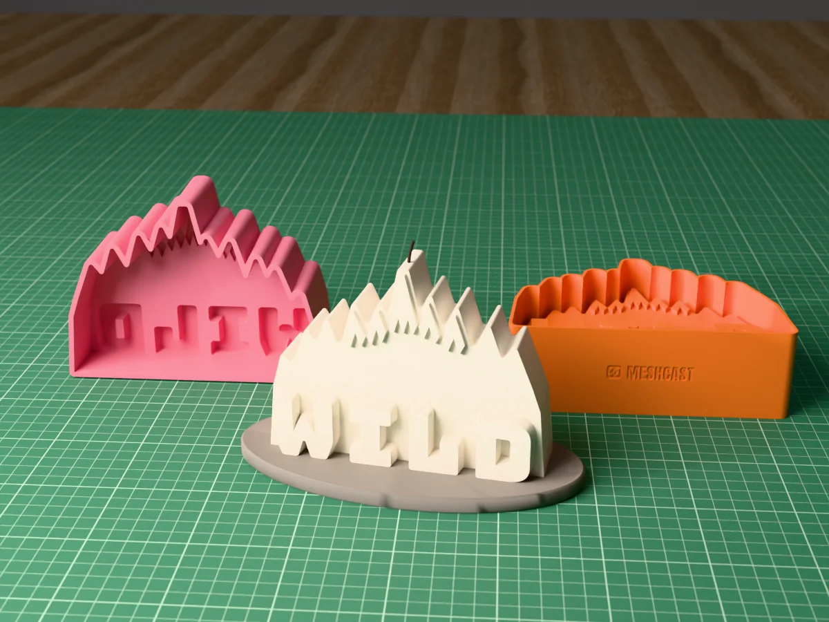 3D render on a green cutting mat: an ivory candle with raised WILD letters in front of jagged peaks on an oval concrete tray, behind it the pink silicone mold with its cavity facing the camera and the orange printed caster