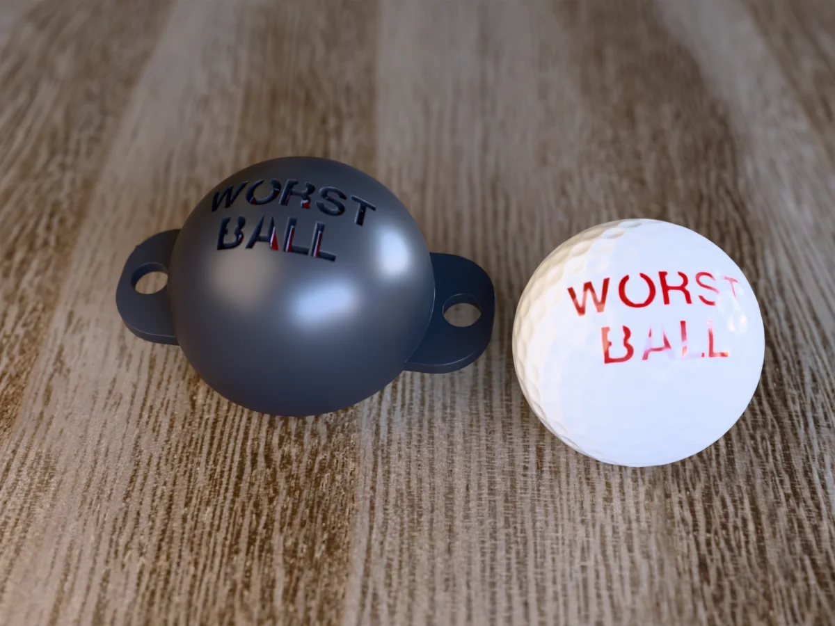 3D render of a black 3D-printed golf ball stencil with WORST BALL cut through it, sitting on a golf ball, next to a ball marked with WORST BALL in red