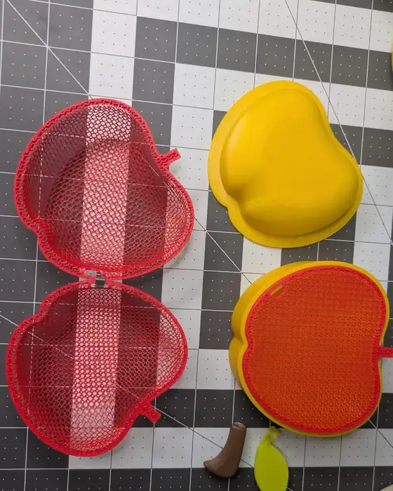 A printed mesh panel opened flat, a yellow press form, and the finished shell heat-pressed from the same technique.