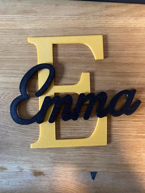 A custom 3D-printed name sign in two colors, made with the Name sign tool.
