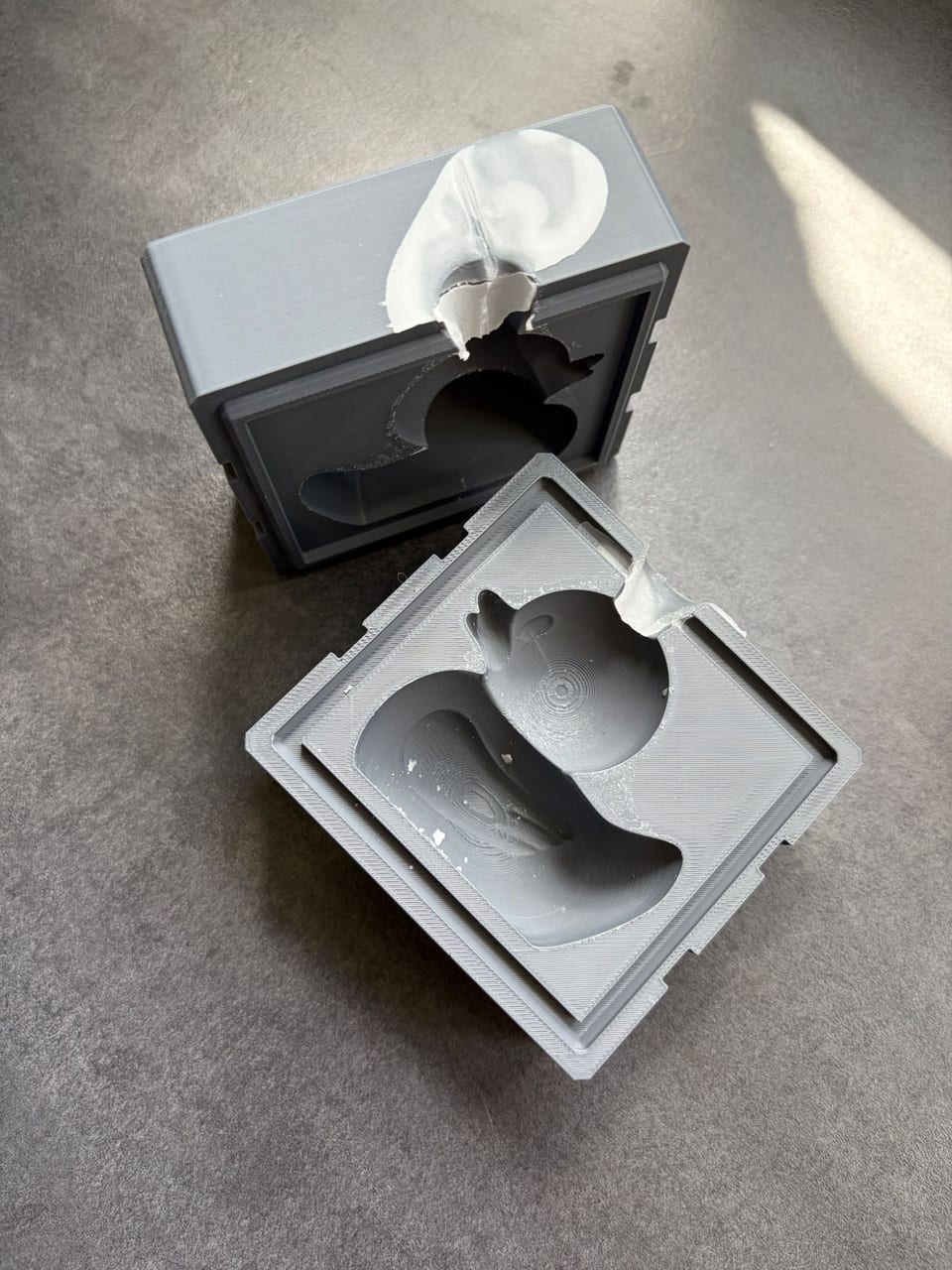 Two-part 3D-printed mold for a duck candle, opened