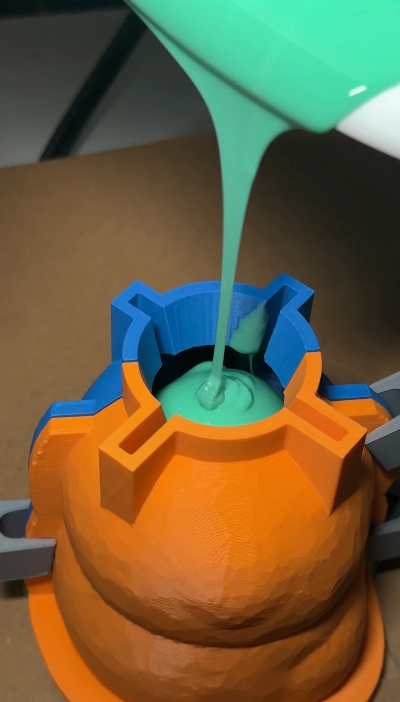 Green silicone poured into a clamped multi-part printed mold