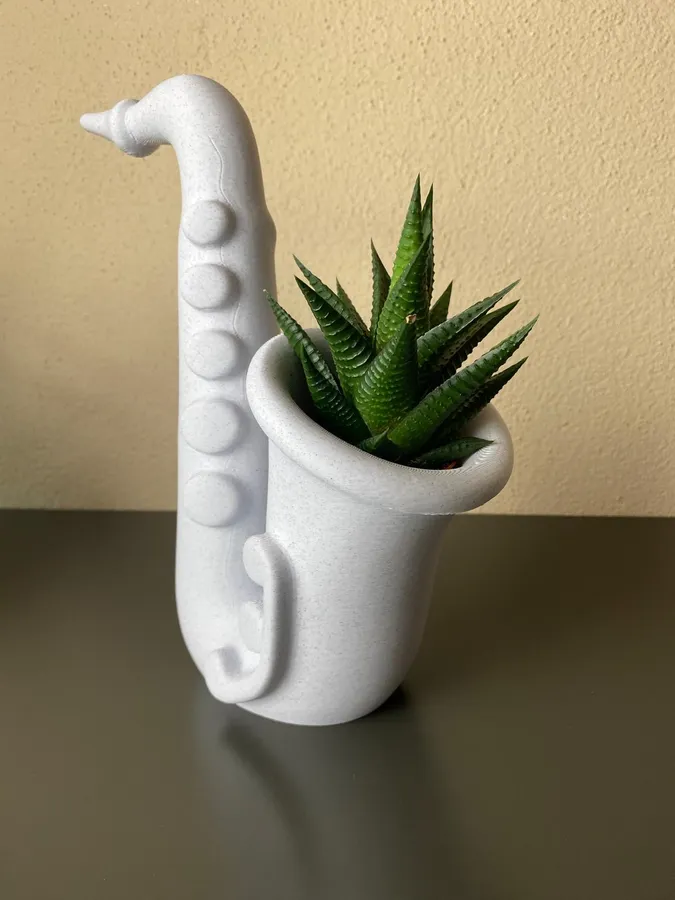 A saxophone-shaped succulent planter, 3D-printed with the Planter tool